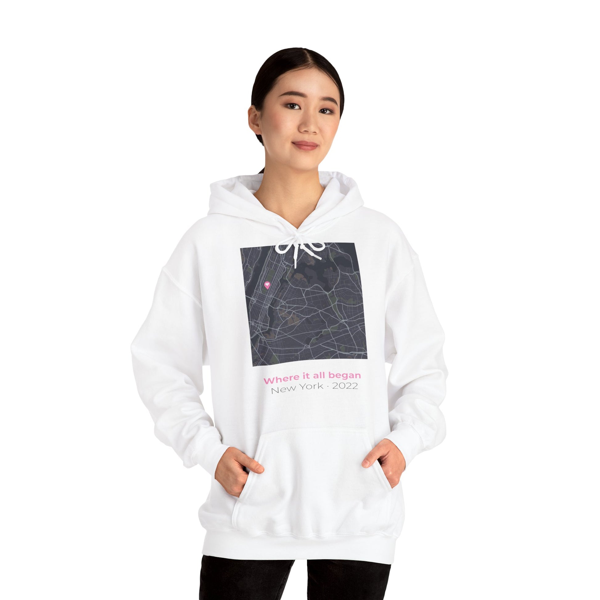 Woman wearing a personalized love map hoodie showing custom city map with heart pin