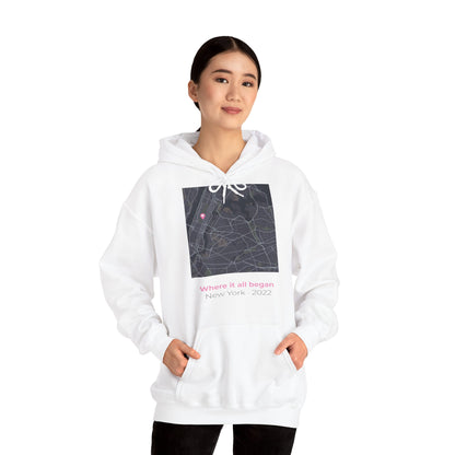 Woman wearing a personalized love map hoodie showing custom city map with heart pin